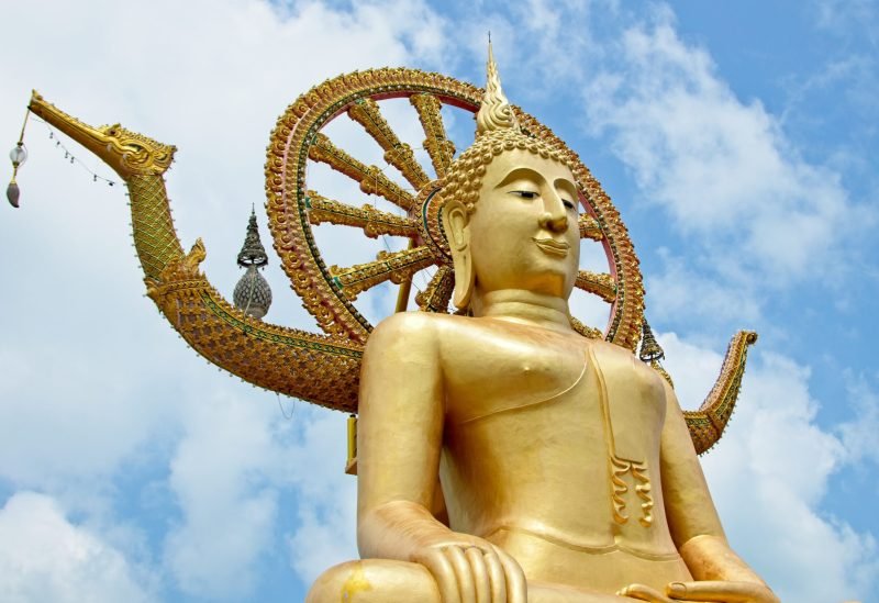The famous historic statue of Buddha touching the sky in Wat Phra Yai temple, Thailand